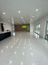 Close-up of wood-look tile flooring with leveling clips used during the installation process.