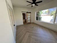 Open-concept living and dining space with light wood plank flooring and a seamless transition between levels.